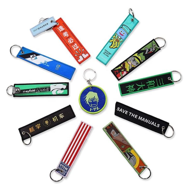 "Custom embroidered keychains with various designs, including 'Save the Manuals', flags, and unique illustrations."