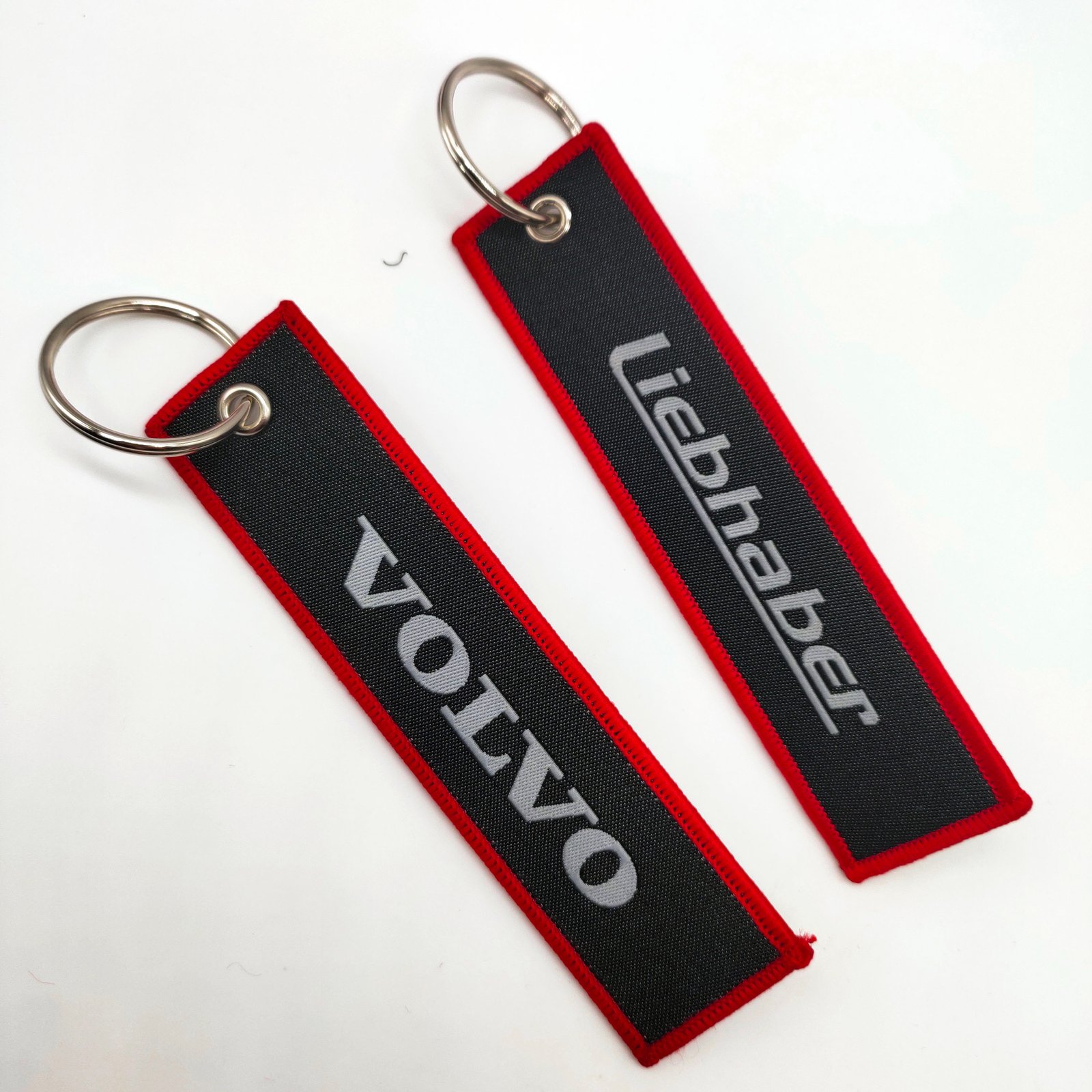 "Wholesale embroidered woven keychains with VOLVO logo"