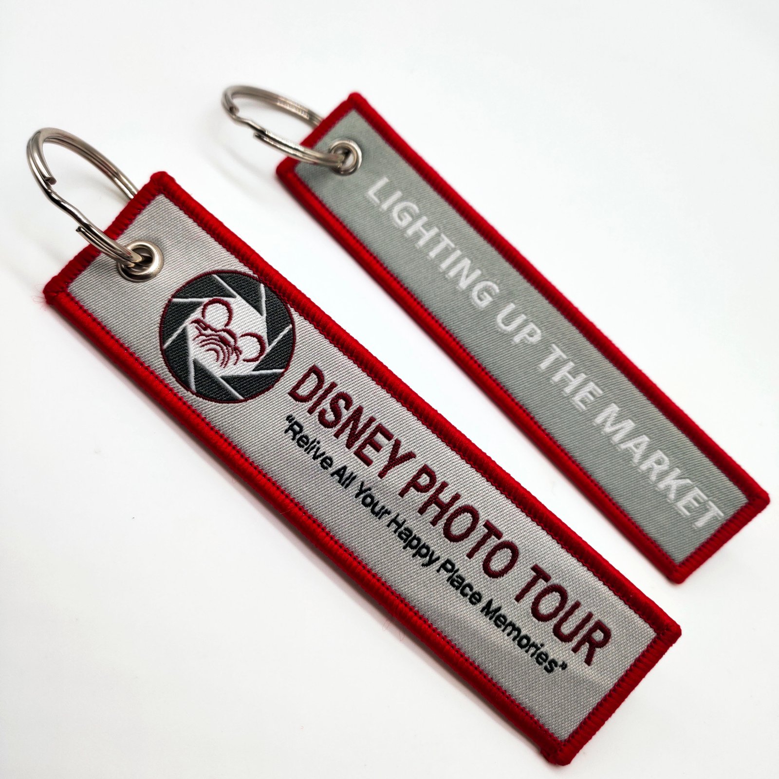 "Disney Photo Tour woven keychains with red and grey designs"