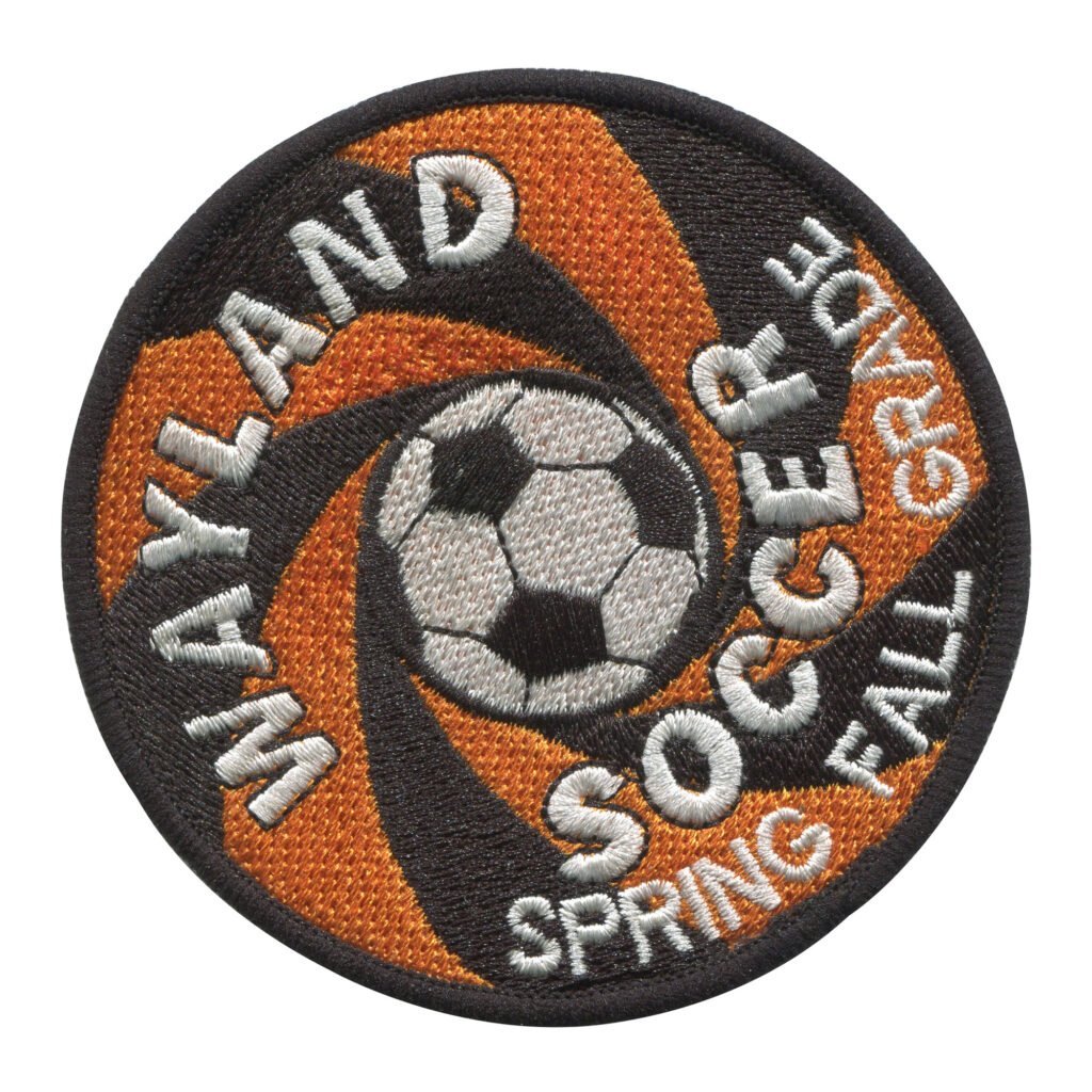 Wayland Soccer Spring Fall Grade Patch with Orange and Black Spiral Design