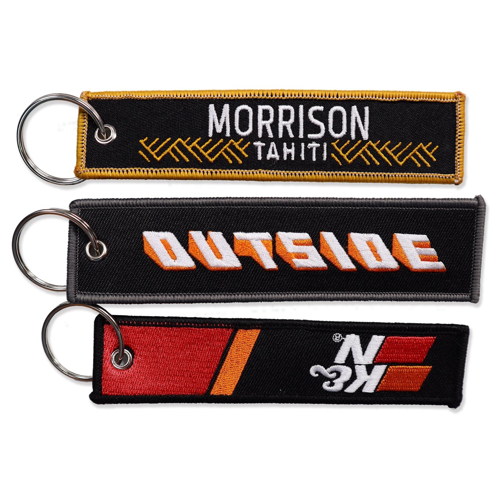 "Bold and colorful embroidered keychains featuring 'Morrison Tahiti' and 'Outside' text designs."