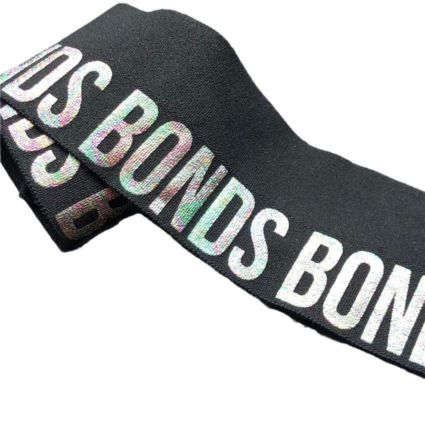 "Black elastic webbing with multicolor holographic 'BONDS' text, designed for fashionable branding and modern apparel."